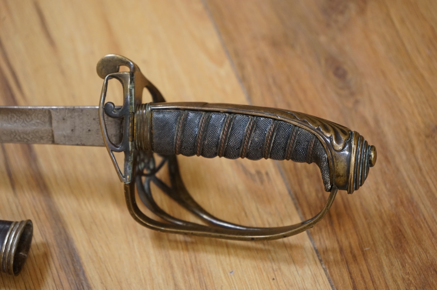 A Victorian 1845 pattern infantry officer’s levee sword, with slender blade etched; Hamburger Rogers & Co., and crowned VR and foliage, regulation pierced brass guard with folding side guard, wire bound fish skin covered